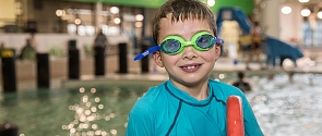 A smiling child is enjoying swim time at Fountain Park