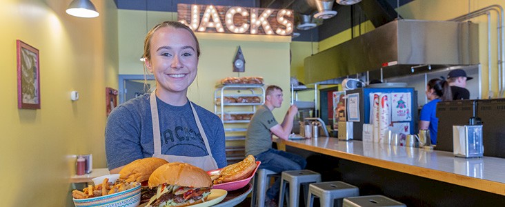 A server welcomes you to Jacks Restaurant