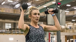 Woman lifting weights at Servus Credit Union Place