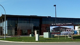 Image of a building with sign in front detailing the information to rent it