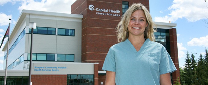Health Care professional in front of Sturgeon Community Hospital