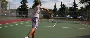 Tennis player serving on the court