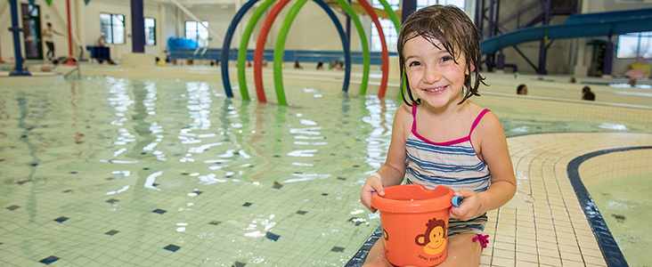 Photo of young swimmer at Landrex Water Play Centre; holding a water toy