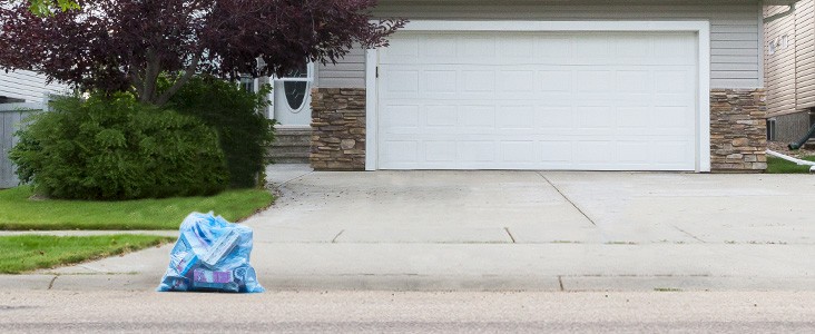 Blue recycling bag at the end of the driveway