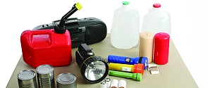 Items including jugs of water, flashlights, canned goods as part of an emergency kit