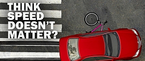 Photo of a banner with the words Think Speed Does Not Matter and a car that hit a bike