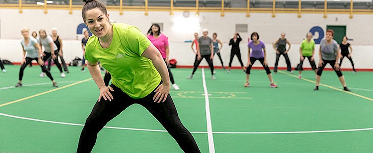 Fitness instructor leading dance class at Servus Place