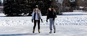 Two skaters on an outdoor rink