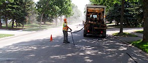 A City employee performs a crack repair