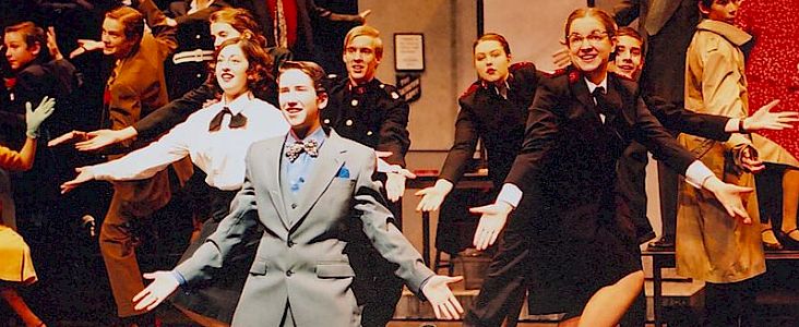 Guys and Dolls cast doing jazz hands