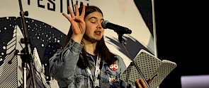 Youth speaking holding four fingers up